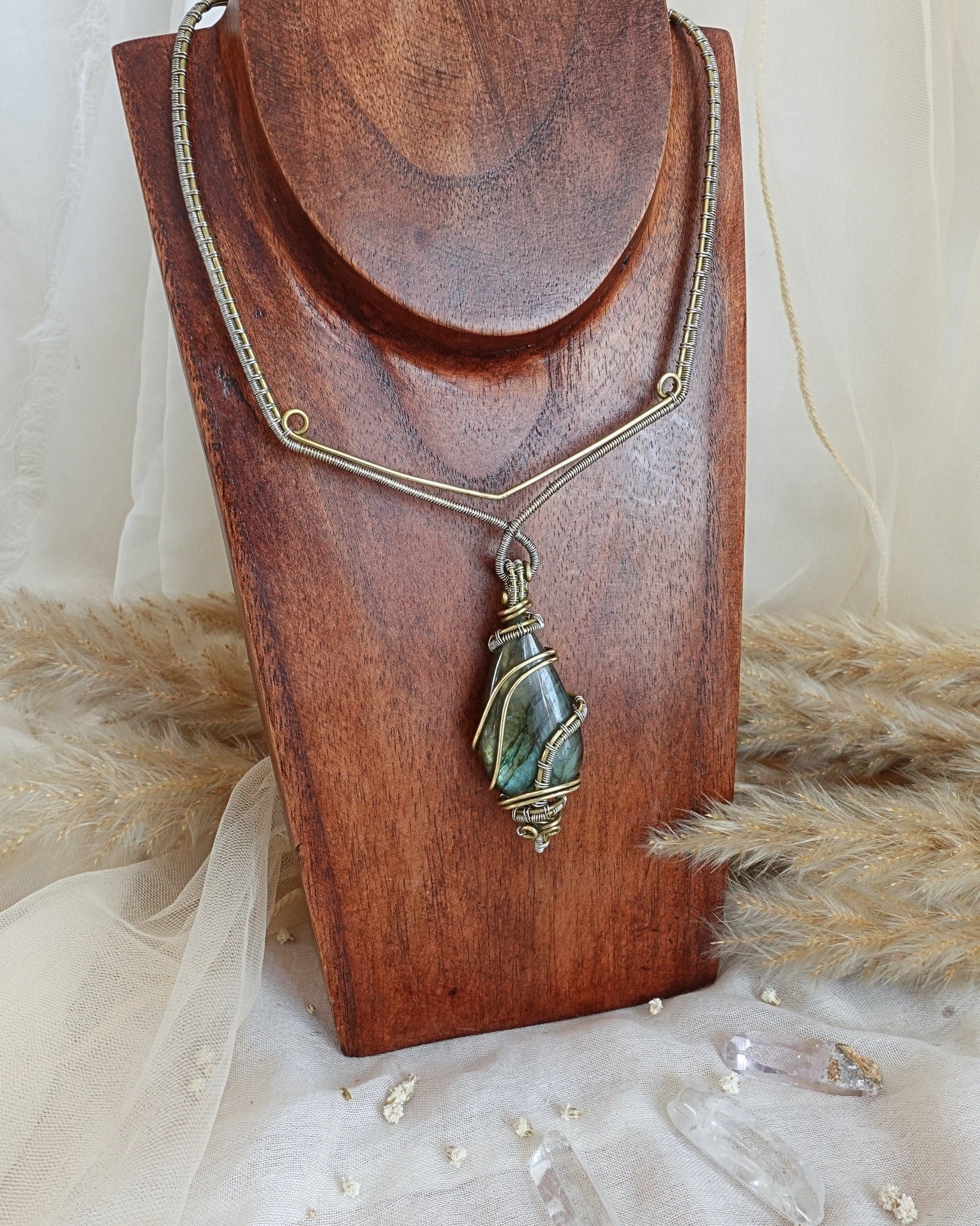 Side view of delicate labradorite wirewrap pendant on brass chain