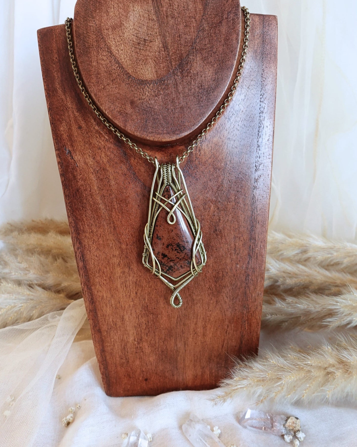 Mahogany obsidian wirewrap pendant showing deep brown stone