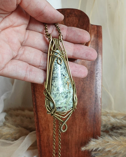 Side view of Mexican turquoise wirewrap pendant on brass chain