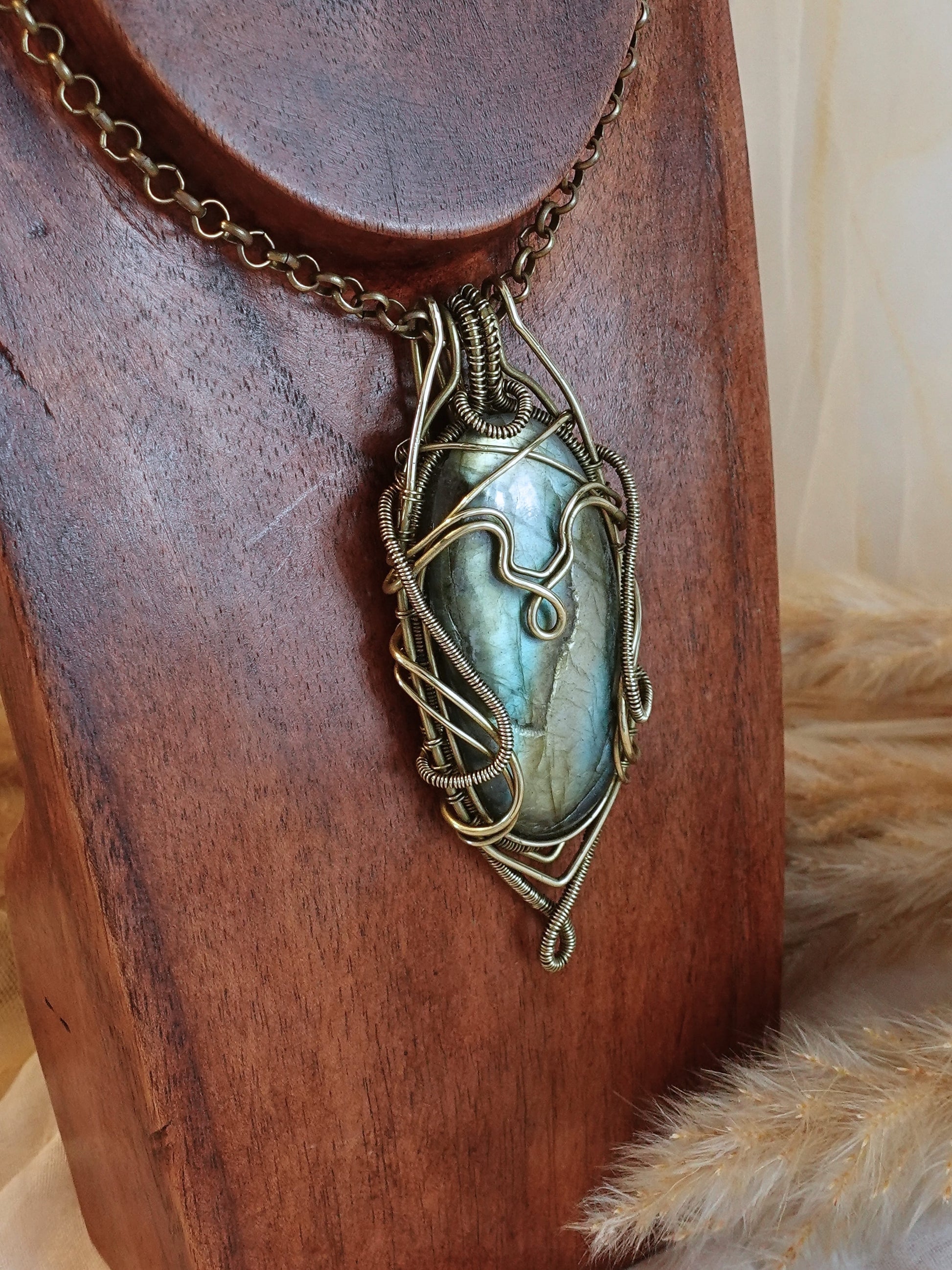 Side view of bold labradorite wirewrap pendant on brass chain