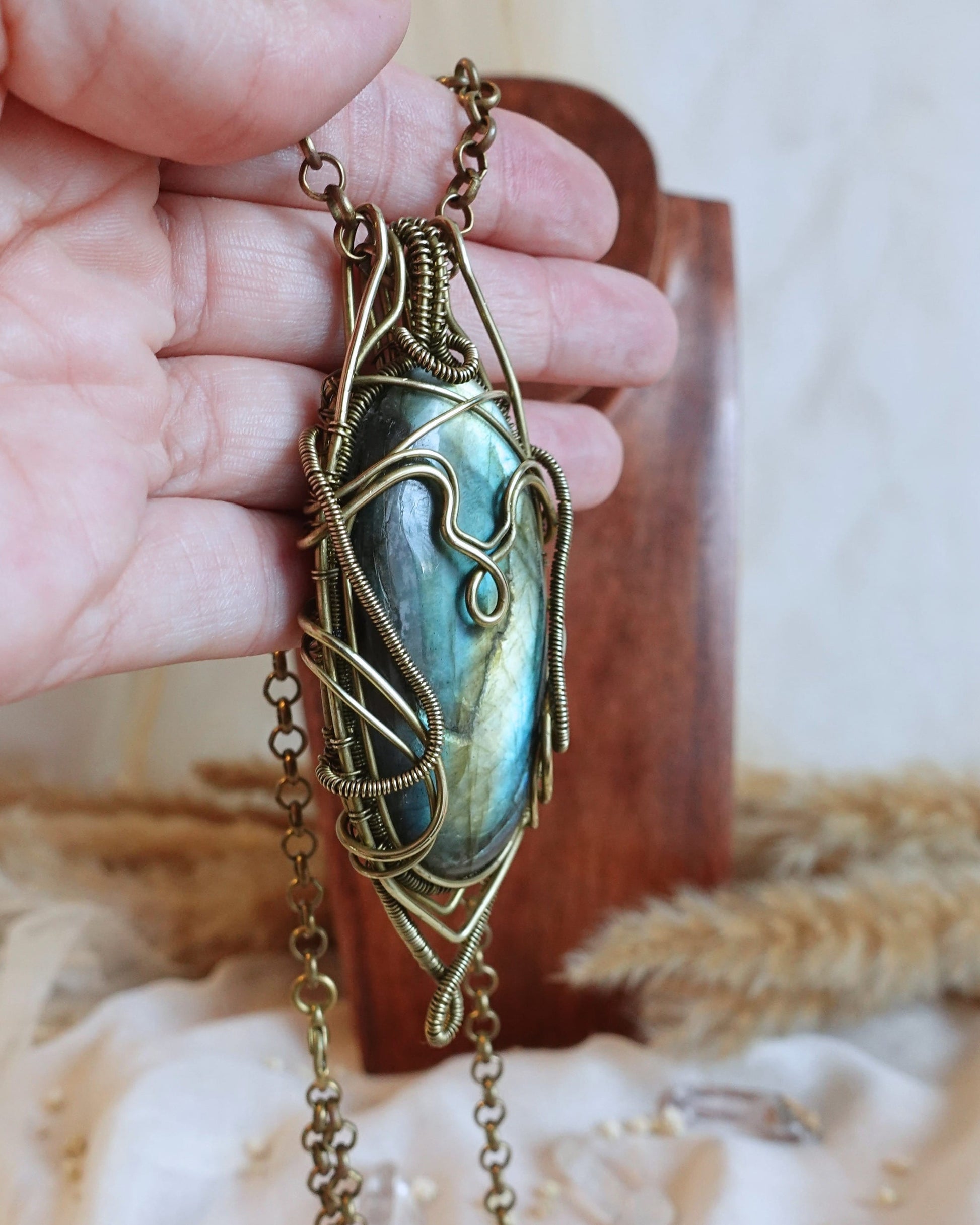 Detail of brass wirework holding the bold labradorite gemstone
