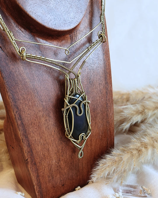 Handmade Black Onyx VÏ necklace with intricate brass wirewrap pendant — front view