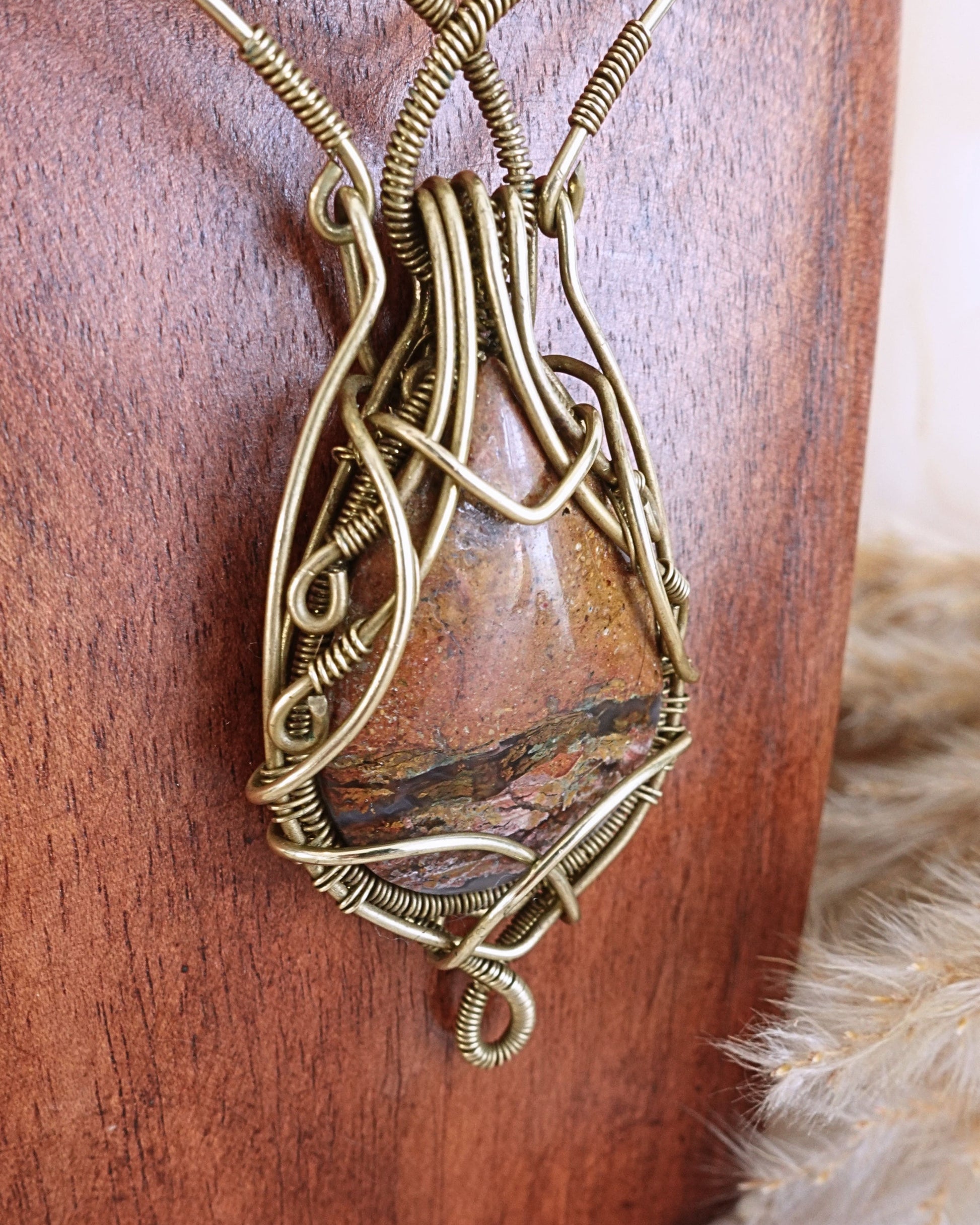 Side view of Ocean Jasper VÏ wirewrap pendant on brass chain