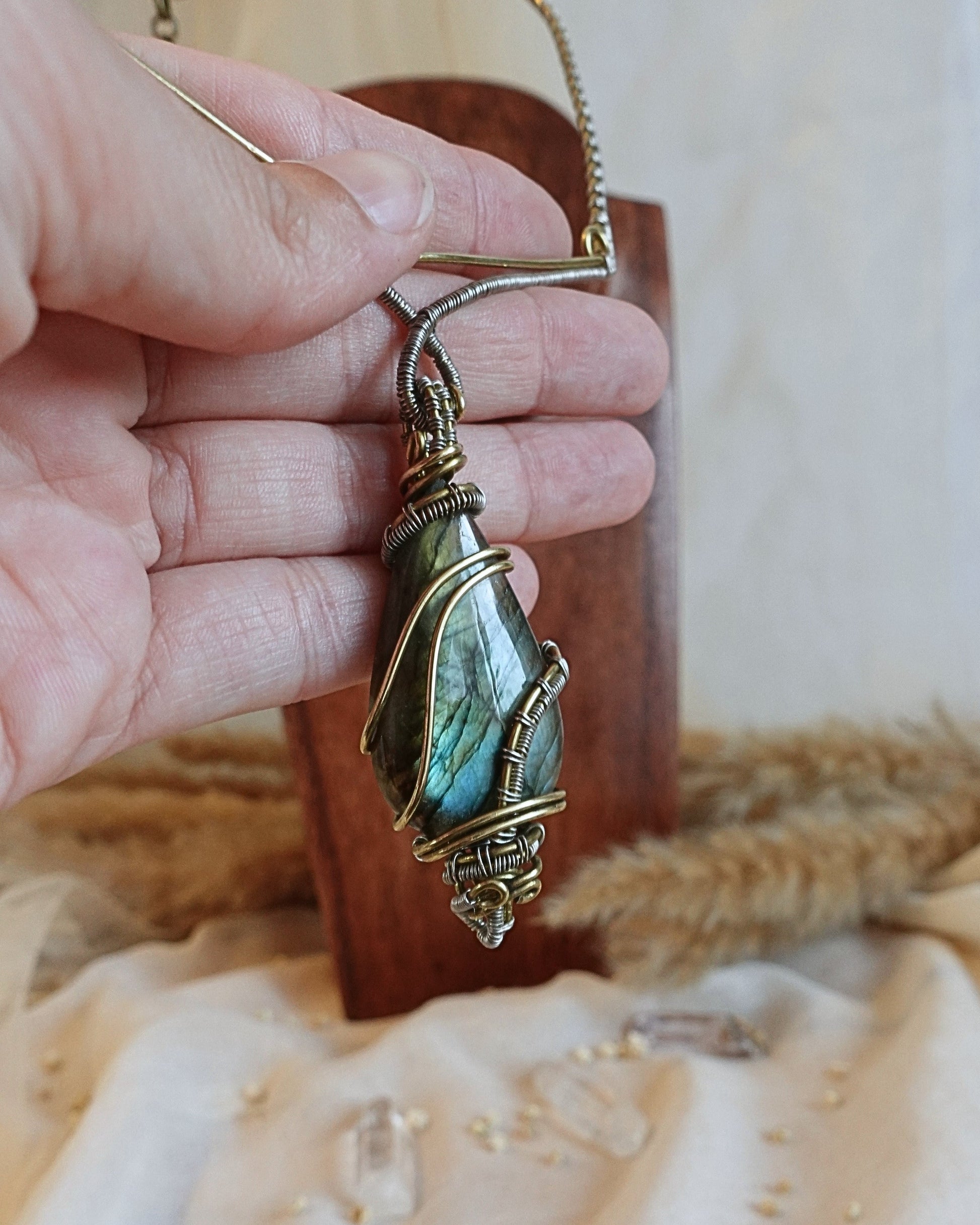 Detail of brass wirework holding the delicate labradorite gemstone