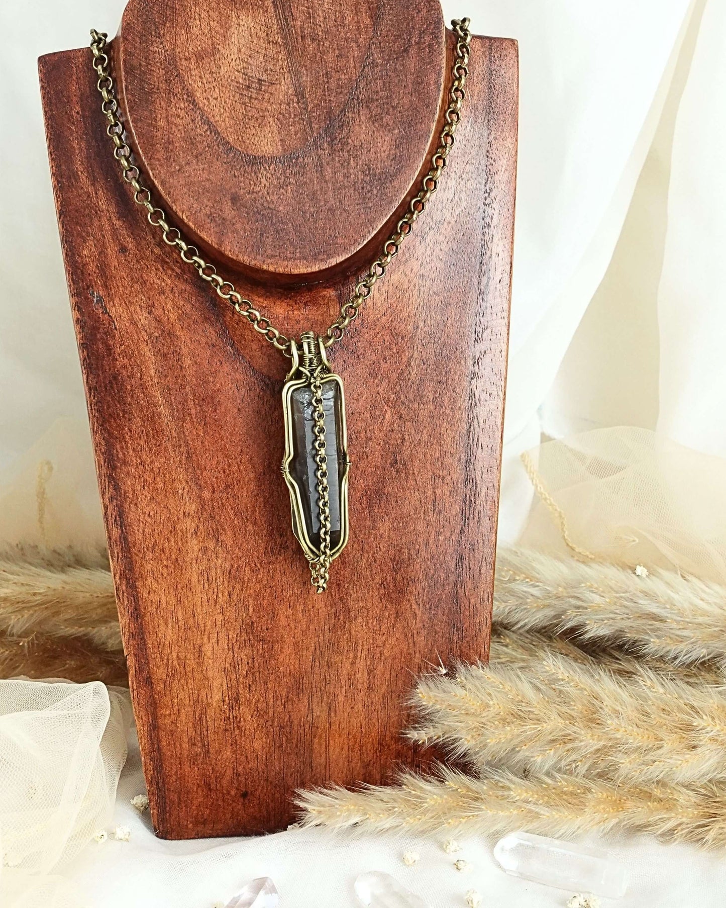 Black quartz pendulum necklace styled on neck — Rikst Jewelry handmade piece