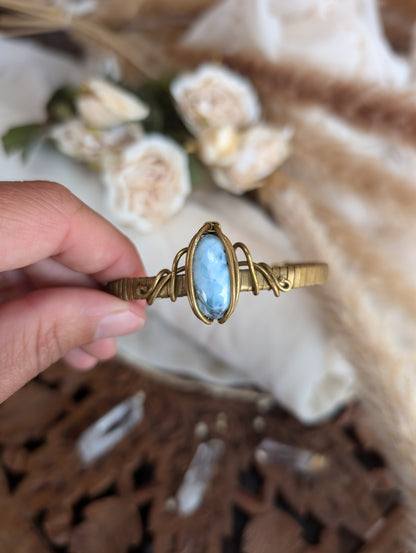 Detail of brass wirework holding the larimar stone