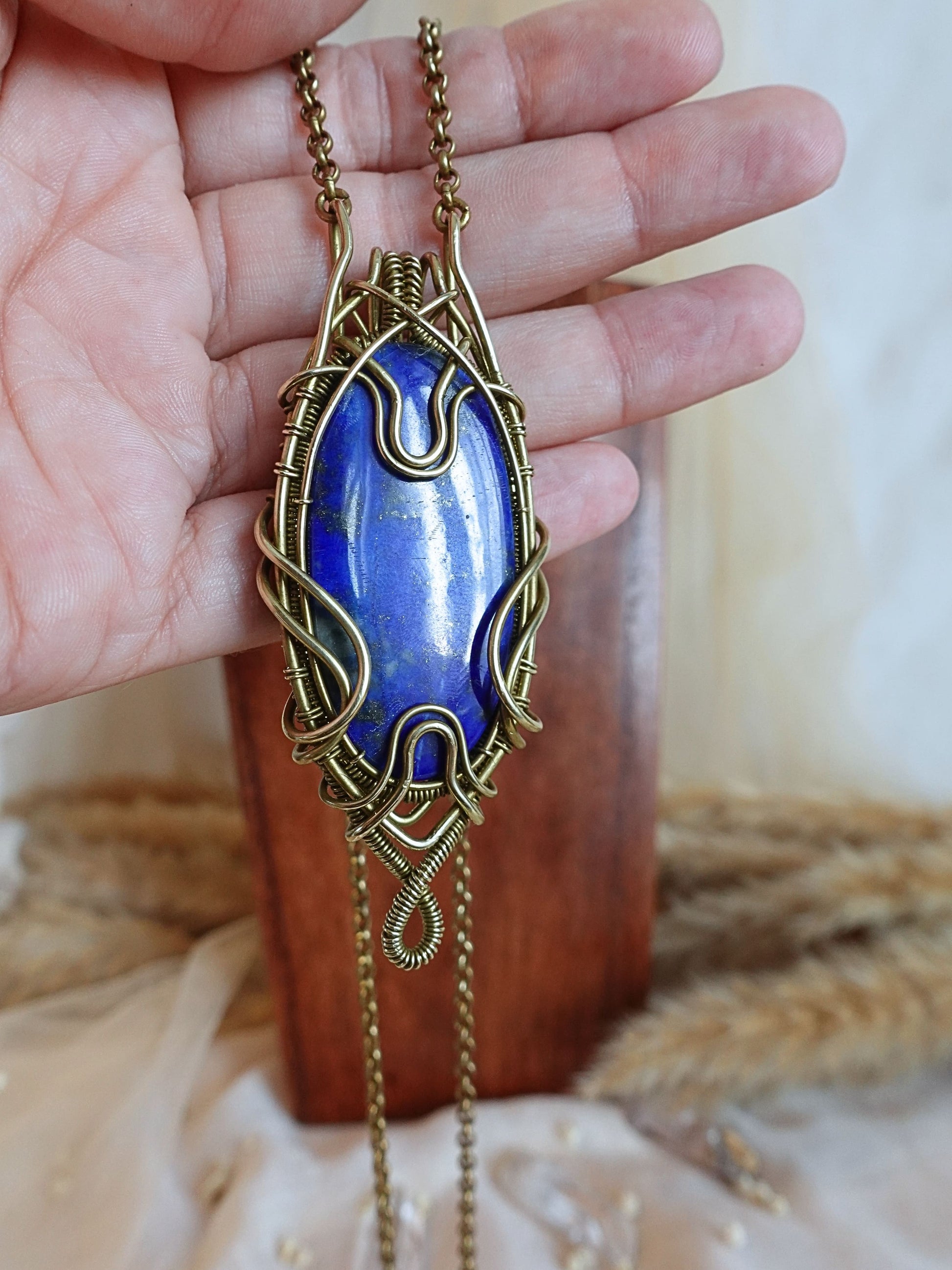 Side view of handmade lapis lazuli wirewrap pendant
