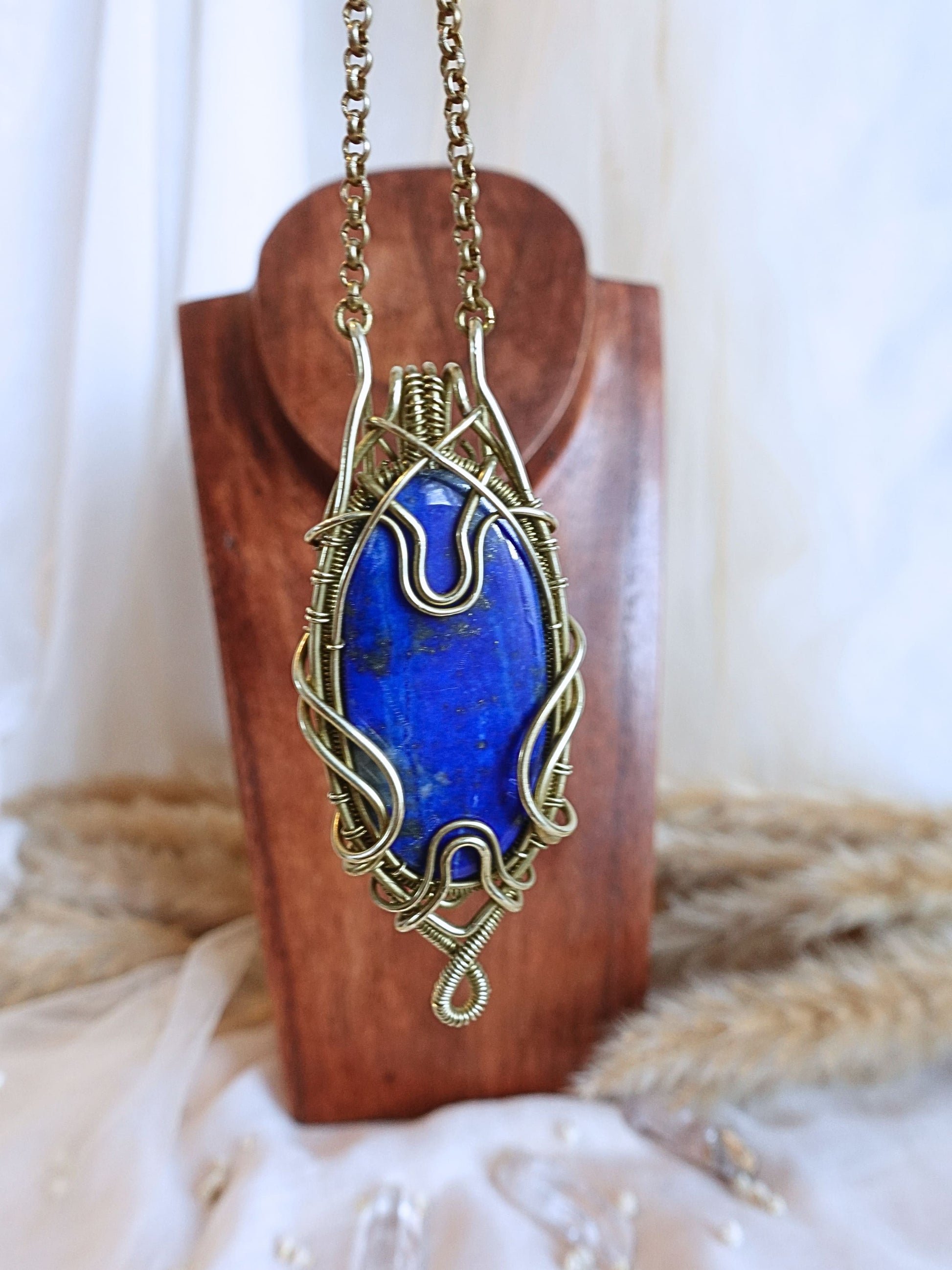 Detail of brass wirework holding the lapis lazuli gemstone
