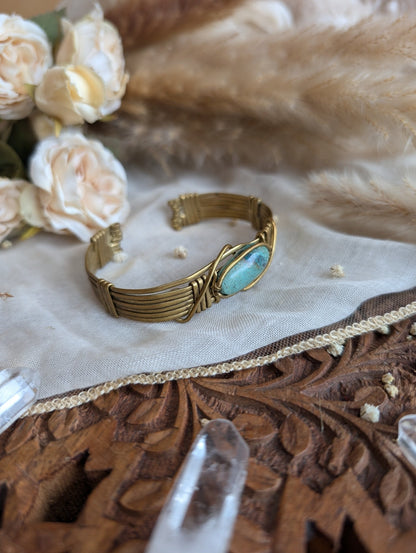 Detail of brass wirework holding the chrysocolla stone