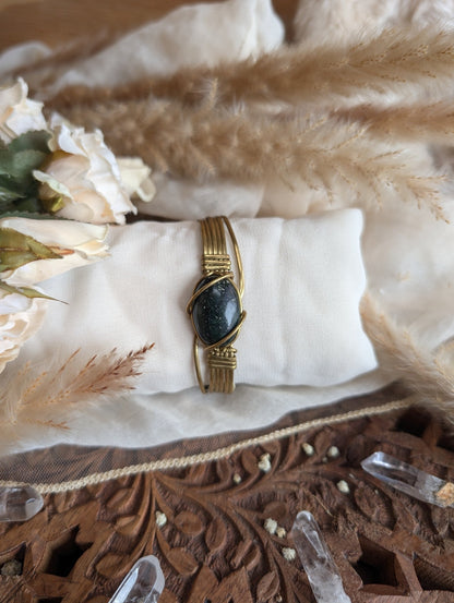 Side view of dark jade bracelet in adjustable brass wire