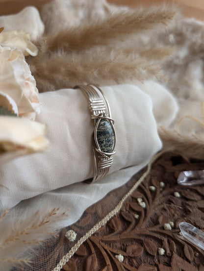 Detail of silver-plated wirework holding the ocean jasper stone