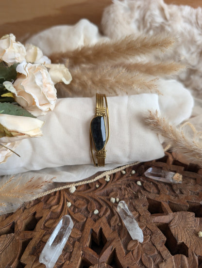 Rainbow obsidian bracelet styled on wrist — Rikst Jewelry handmade piece