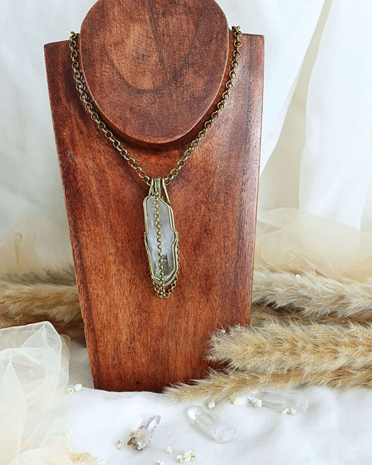 Clear quartz pendulum pendant showing transparent crystal point