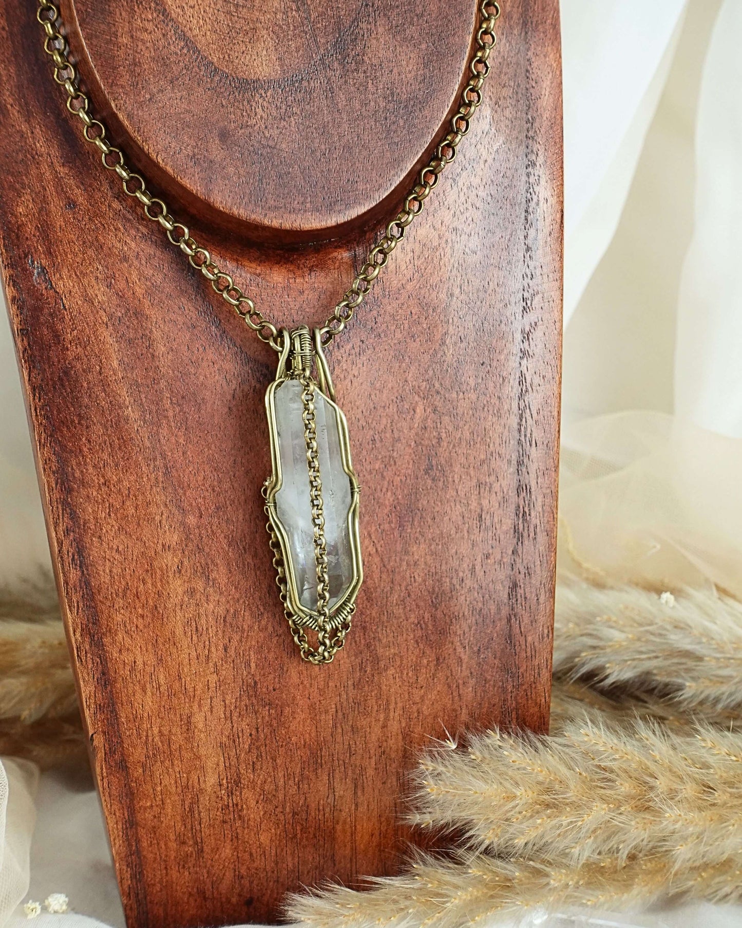 Handmade clear quartz pendulum necklace with brass wirewrap pendant — front view