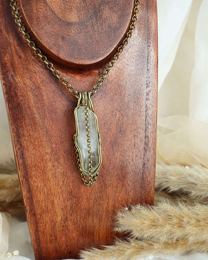 Handmade clear quartz pendulum necklace with brass wirewrap pendant — front view