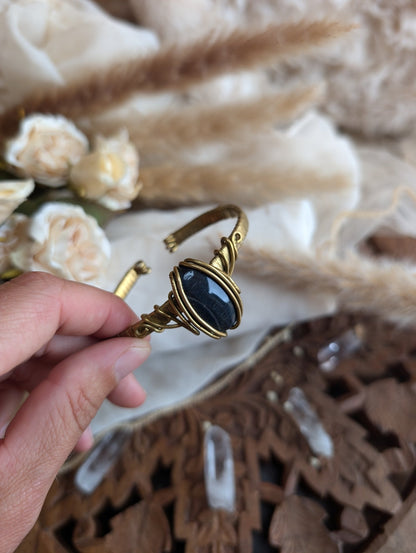 Detail of brass wirework holding the blue tiger eye stone