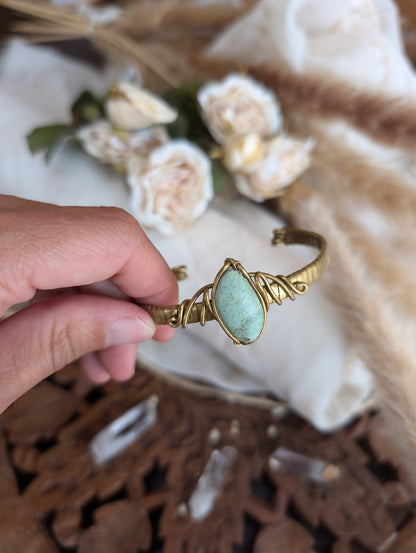 Detail of brass wirework holding the chrysocolla stone